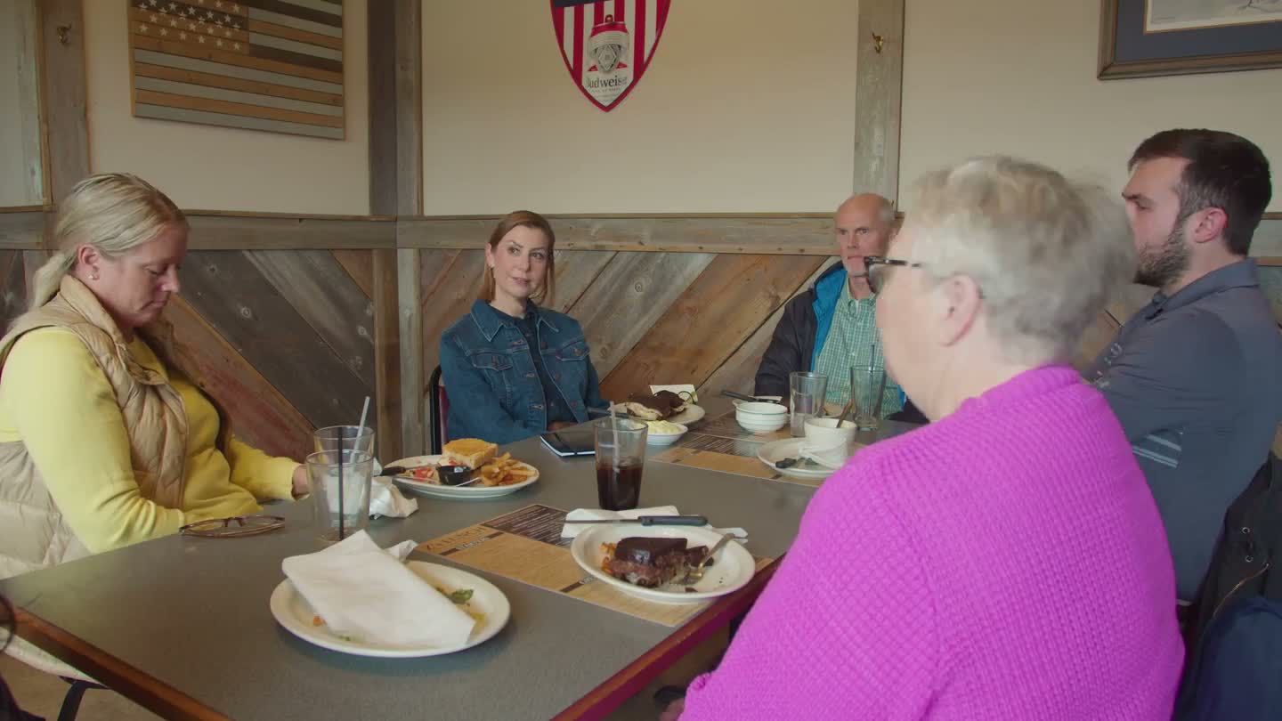 A Majority Democrats member with constituents around a table